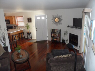 Living room with hardwood floors, electric firepla