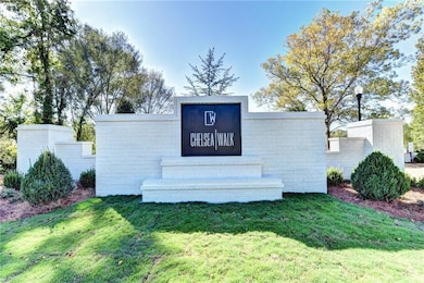 Community / neighborhood sign featuring a lawn