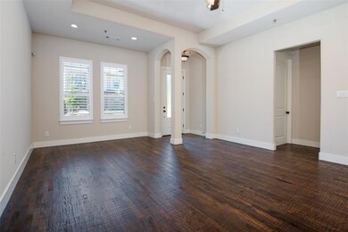 Beautiful wood floors, tall tray ceilings, and plantation shutters give this town home a custom look and feel.