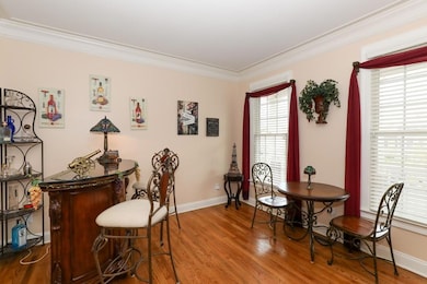 Dining space with a bar, baseboards, ornamental mo