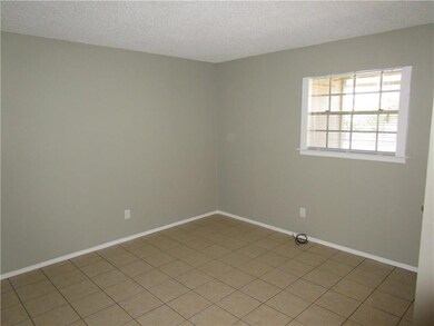 Spare room featuring baseboards, light tile patte