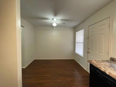Empty room featuring ceiling fan and dark wood-typ