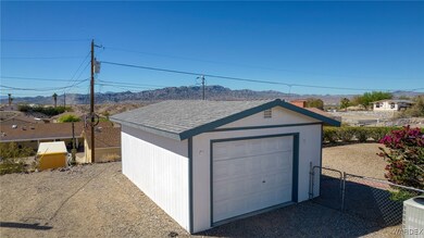 Detached garage featuring fence and a mountain vie