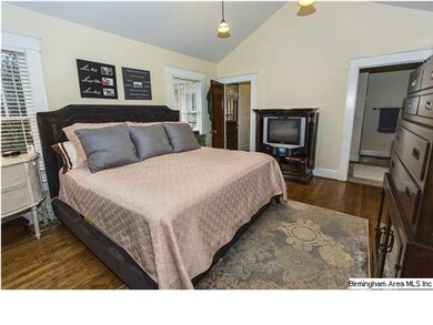 Master bedroom with vaulted ceilings and hardwood 
