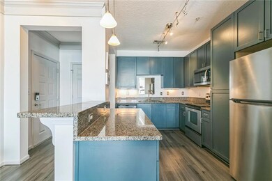 Kitchen featuring light stone counters, appliances