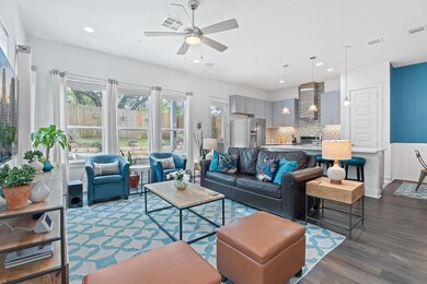 Living room with visible vents, dark wood-style f