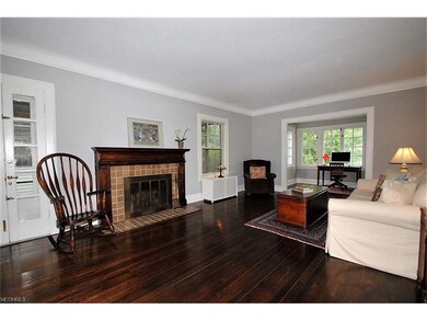 LOVELY FORMAL LIVING ROOM HAS WOOD FLOORING AND FI