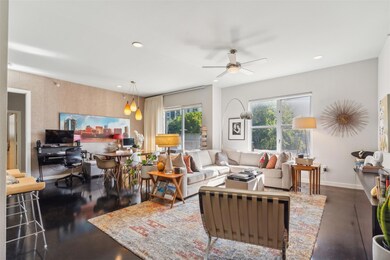 Living room featuring a healthy amount of sunlight and ceiling fan