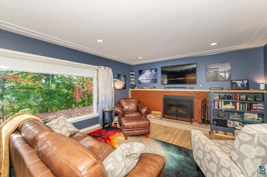 Living room featuring a brick fireplace and hardwo