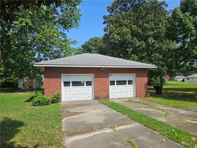 Garage featuring a lawn