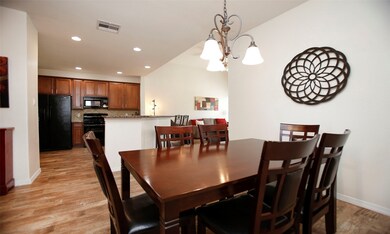 Dining view into the open kitchen.  Love the wood