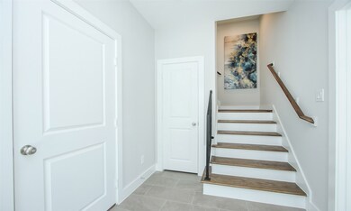 Ceramic tile inviting entry with wood floor stairs