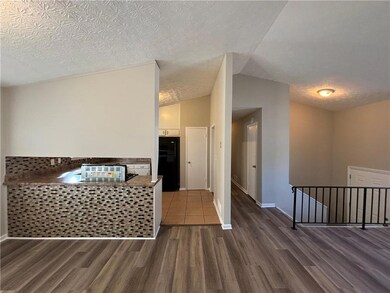 Kitchen with vaulted ceiling, wood finished floors
