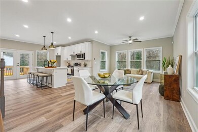 Dining area with french doors, a ceiling fan, orna