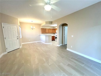 Unfurnished living room with arched walkways, ceil
