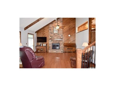 Front room with gleaming hardwood floor and firepl