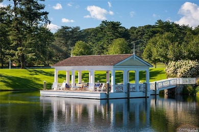 Dock featuring a water view and a yard