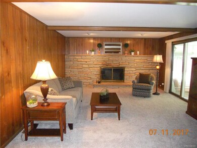 Family Room with beamed ceiling, fireplace and sli