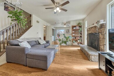 This family room features a cozy stone fireplace, 