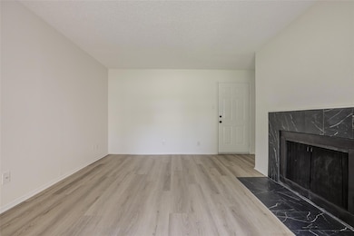 Unfurnished living room featuring wood finished f