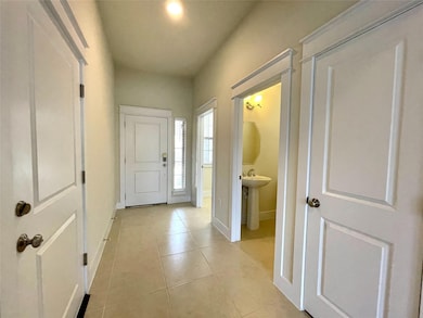 Foyer featuring light tile patterned floors and b