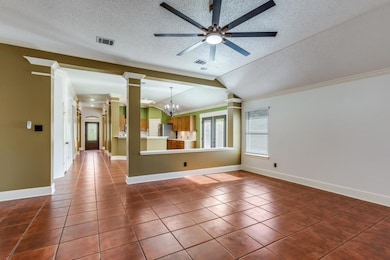 Unfurnished room featuring vaulted ceiling, a tex