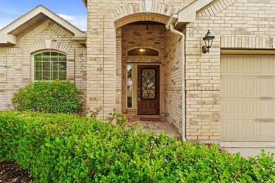 An impressive covered entry, featuring a leaded gl