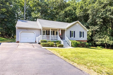 Single story home with a porch, an attached garage