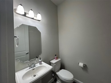 Half bath with a sink and toilet