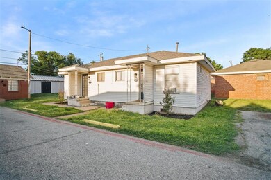 Bungalow featuring a front lawn and an outbuilding