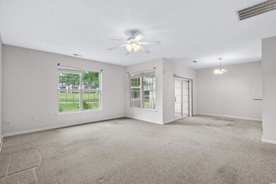Spare room with a textured ceiling, ceiling fan wi