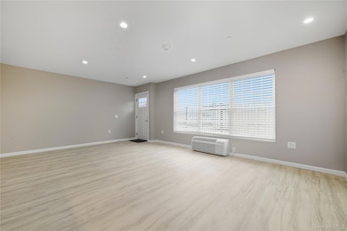 Living Room with Plenty of Natural Light, Luxury Vinyl Flooring, Recessed Lighting, and Ductless CAC & Heat