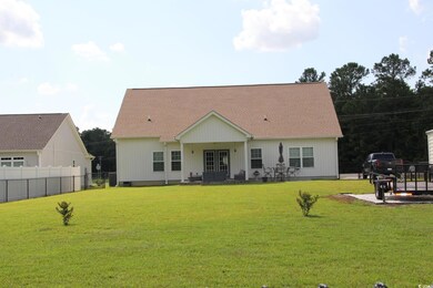 Back of property featuring french doors and roof with shingles