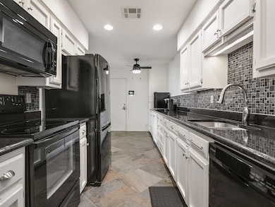 Kitchen with black appliances, ceiling fan, white