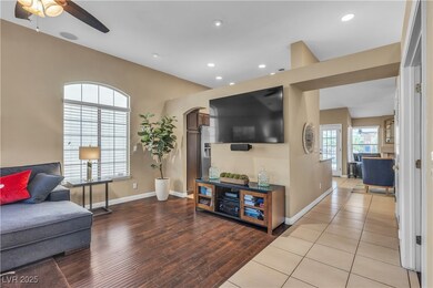 Living room with a ceiling fan, recessed lighting,