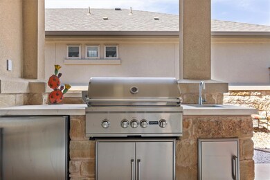 View of patio with a grill, a sink, and exterior 