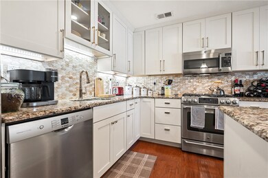 Beautiful backsplash ties in with the Granite coun