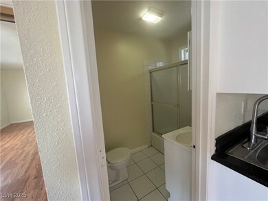 Full bathroom featuring toilet, a sink, a shower w