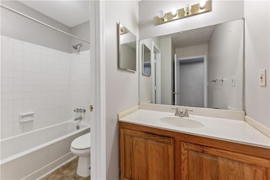 Full bath featuring vanity, tub / shower combination, and tile patterned floors