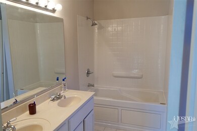 Double sink in master suite along with a jacuzzi t