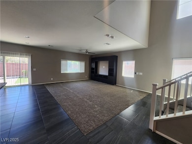 Unfurnished living room with a ceiling fan, basebo