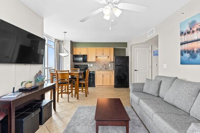 Living room featuring sink, light tile patterned f
