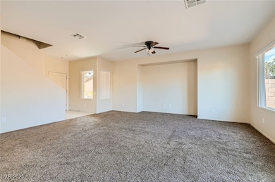 Carpeted empty room with a ceiling fan
