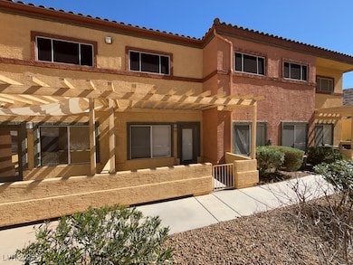 Rear view of house featuring a pergola and stucco