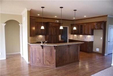 Open kitchen with granite counter tops and huge wa