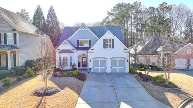 View of front of property featuring concrete driveway, a standing seam roof, an attached garage, metal roof, and stucco siding