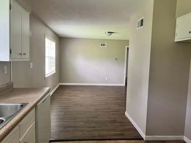 Kitchen featuring white cabinets, sink, stainless 