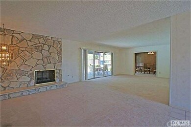 Spacious Living room with rock fireplace and pool 