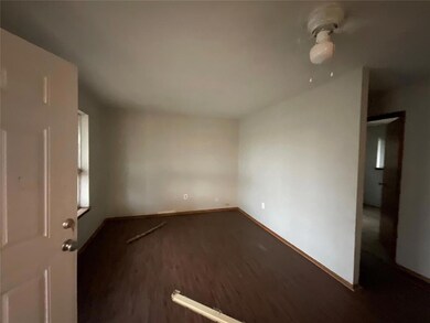 Unfurnished room featuring dark wood-type flooring