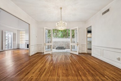 As you make your way through pocket doors, enter the formal dining room! Seamless access to the atrium, kitchen, and living room make for easy living.